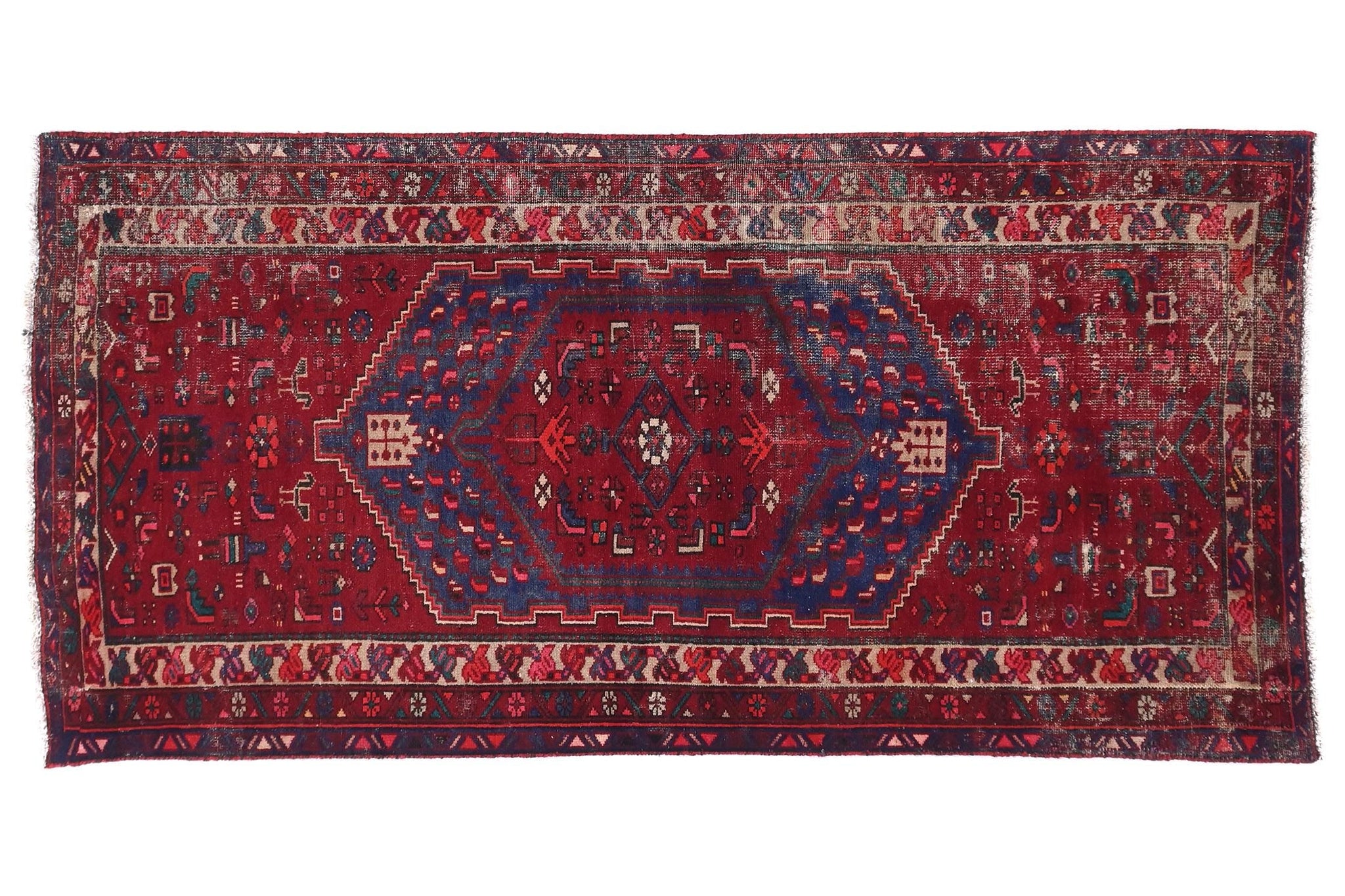 Red and blue patterned rug on a white background