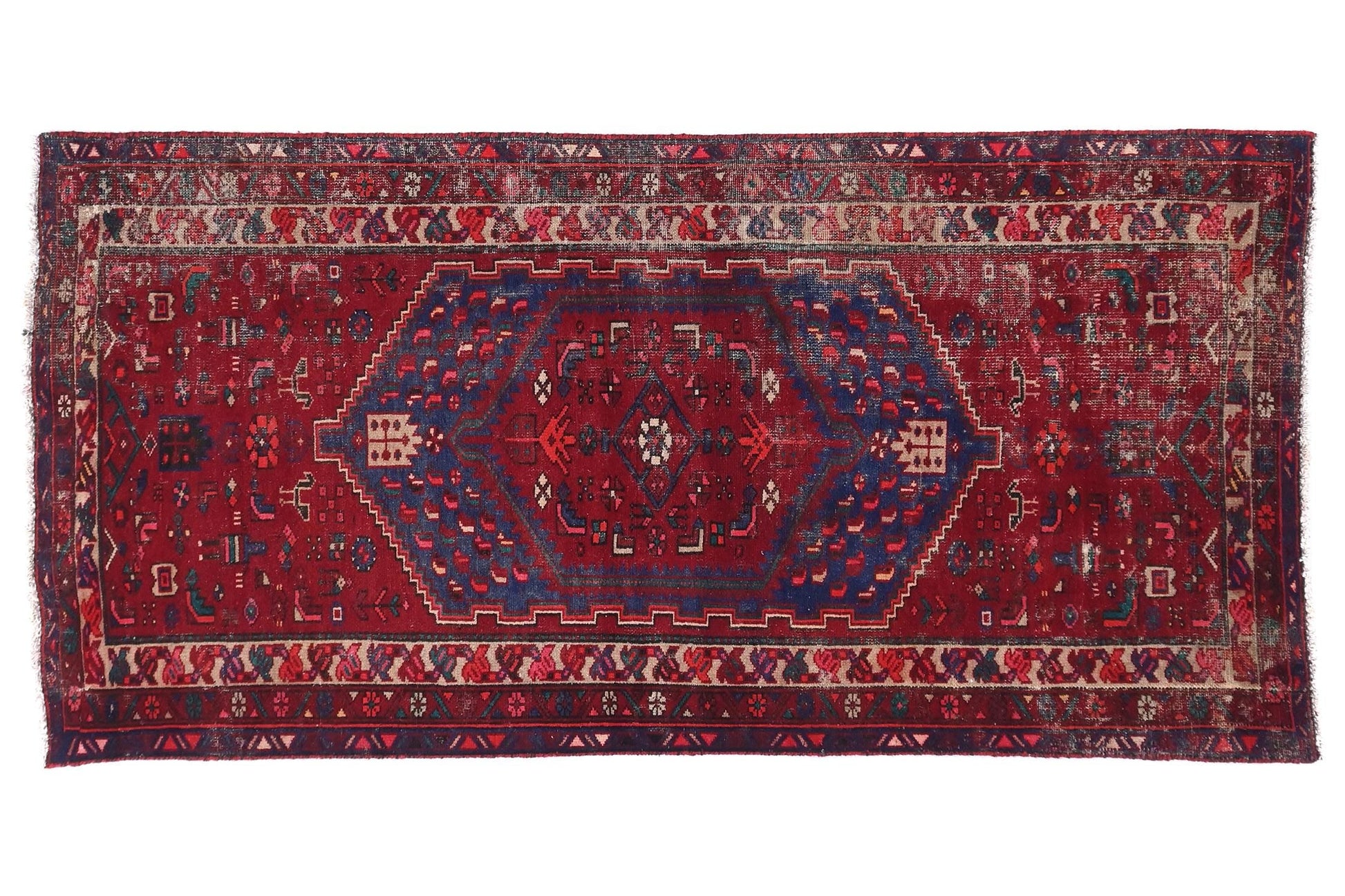 Red and blue patterned rug on a white background