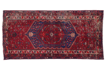 Red and blue patterned rug on a white background