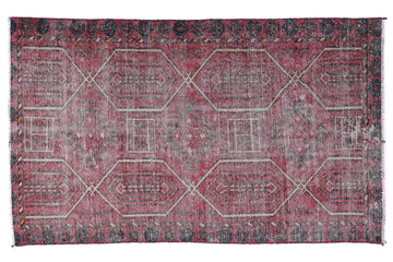Red and gray patterned rug on a white background