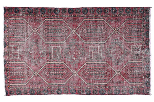 Red and gray patterned rug on a white background