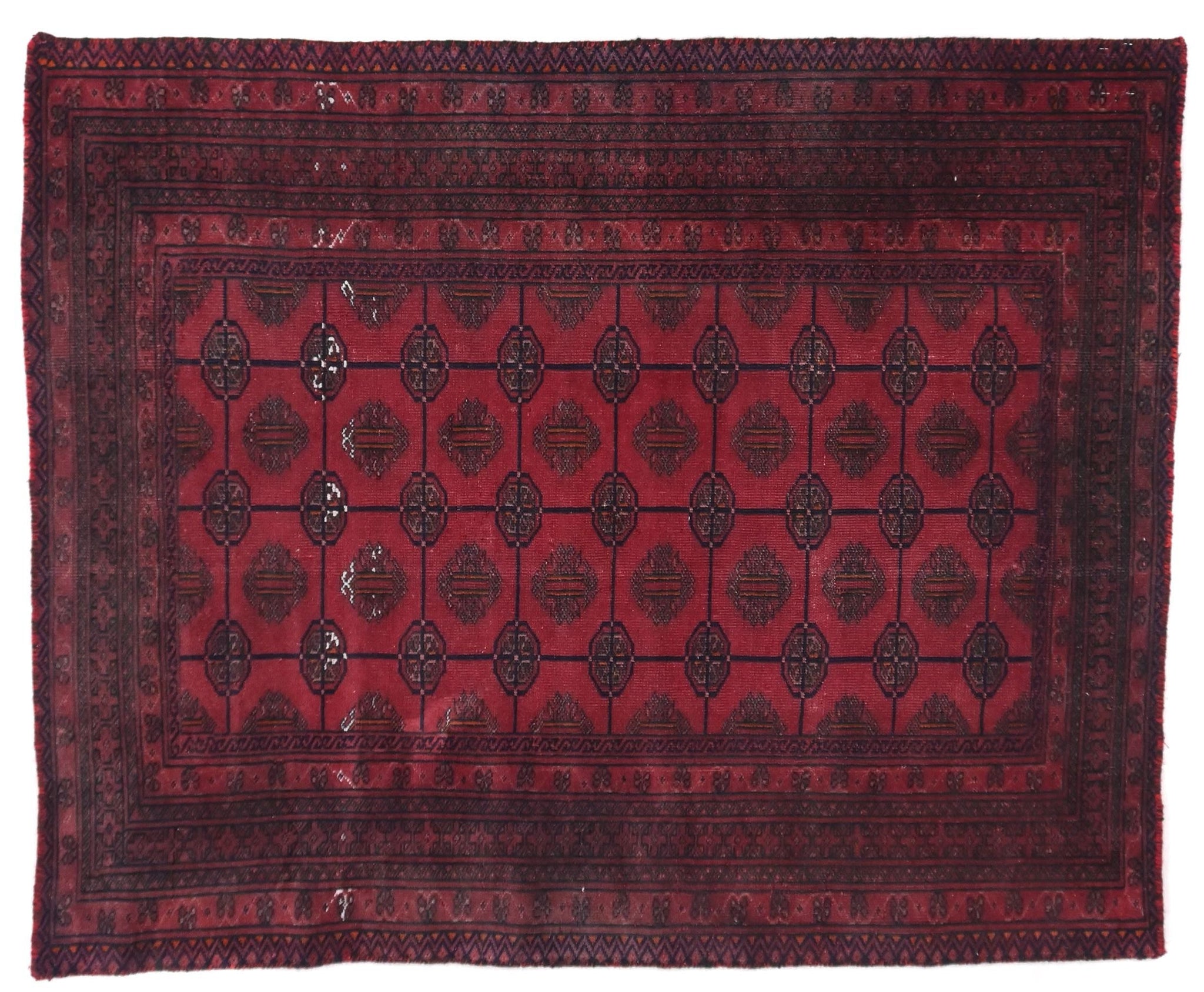 Red and black patterned rug on a white background