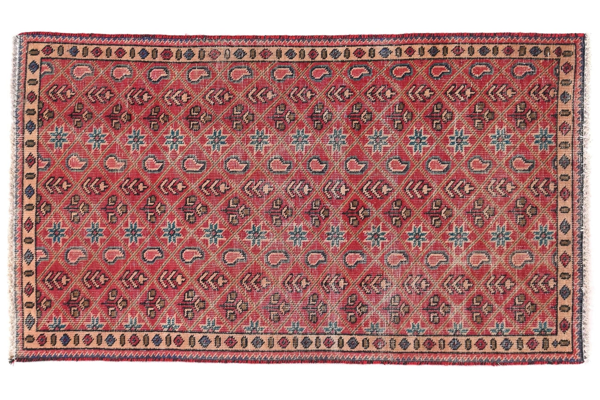 Decorative red rug with intricate patterns on a white background