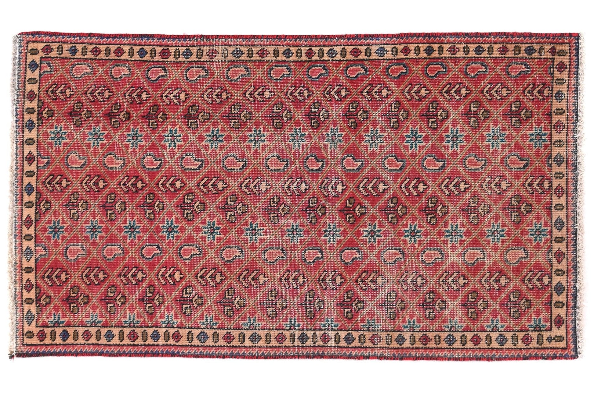 Decorative red rug with intricate patterns on a white background