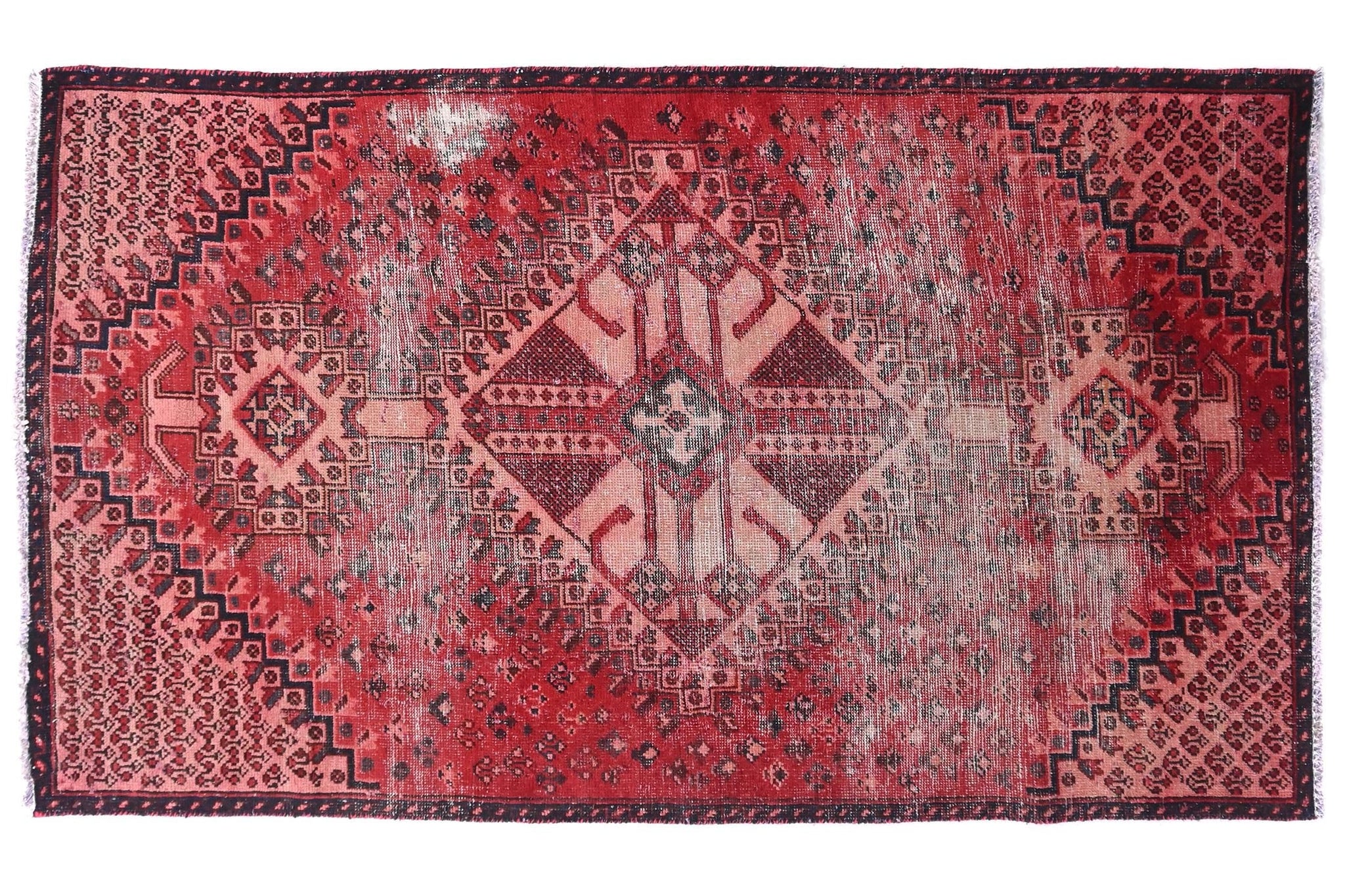 Red patterned rug on a white background