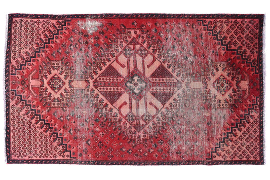 Red patterned rug on a white background