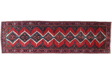 Red and black patterned rug on a white background