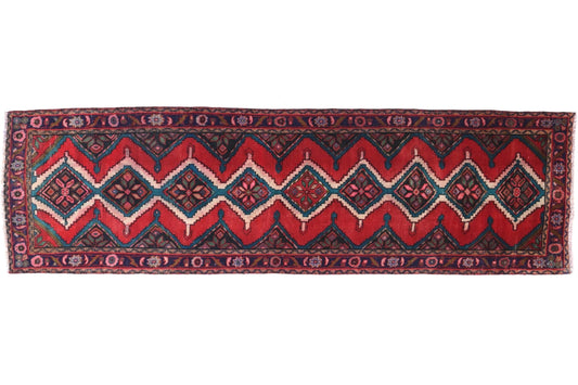 Red and black patterned rug on a white background
