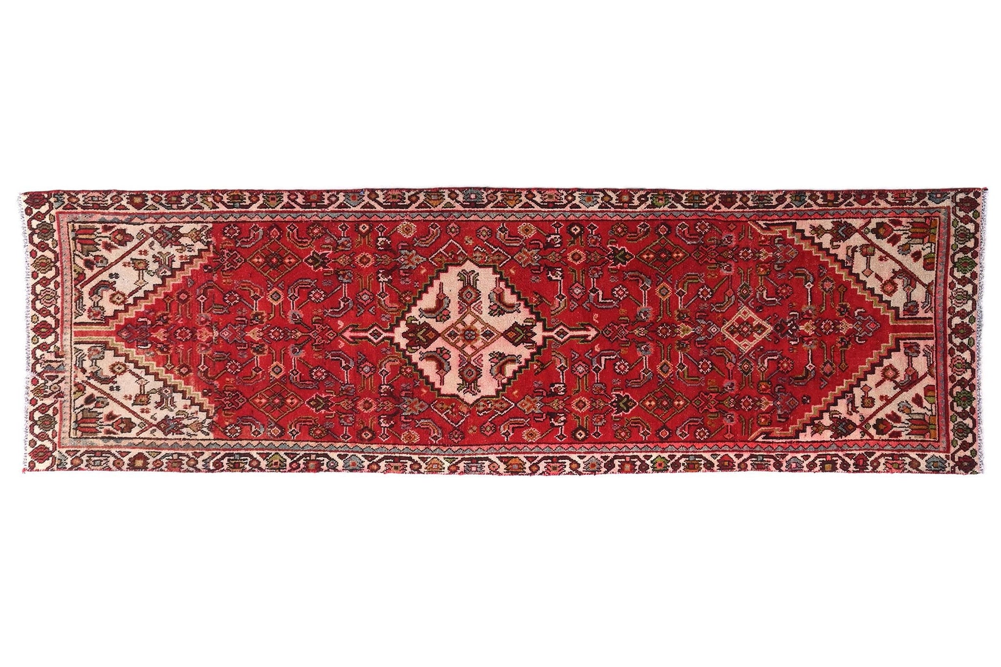 Red patterned rug on a white background