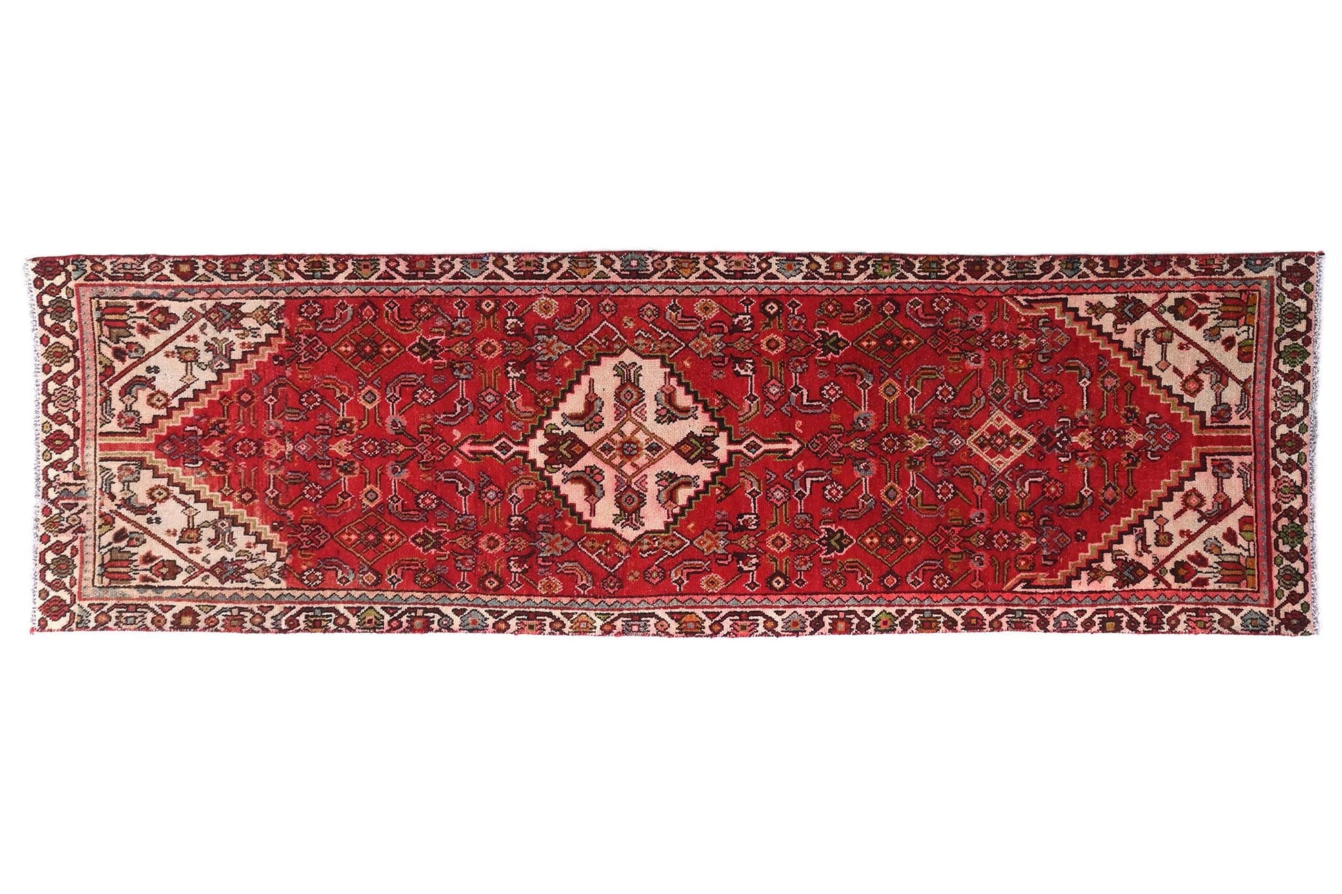 Red patterned rug on a white background